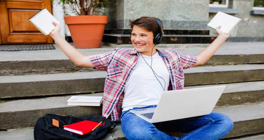 happy-man-with-notepads-laptop